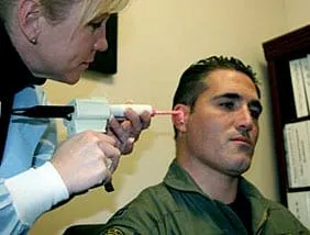 Audiologist taking an earmold impression. 