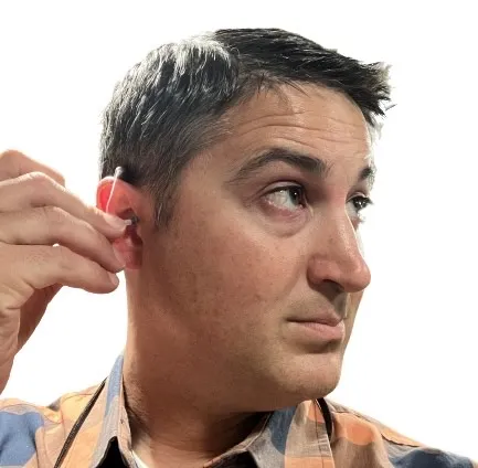 putting on open fit hearing aid